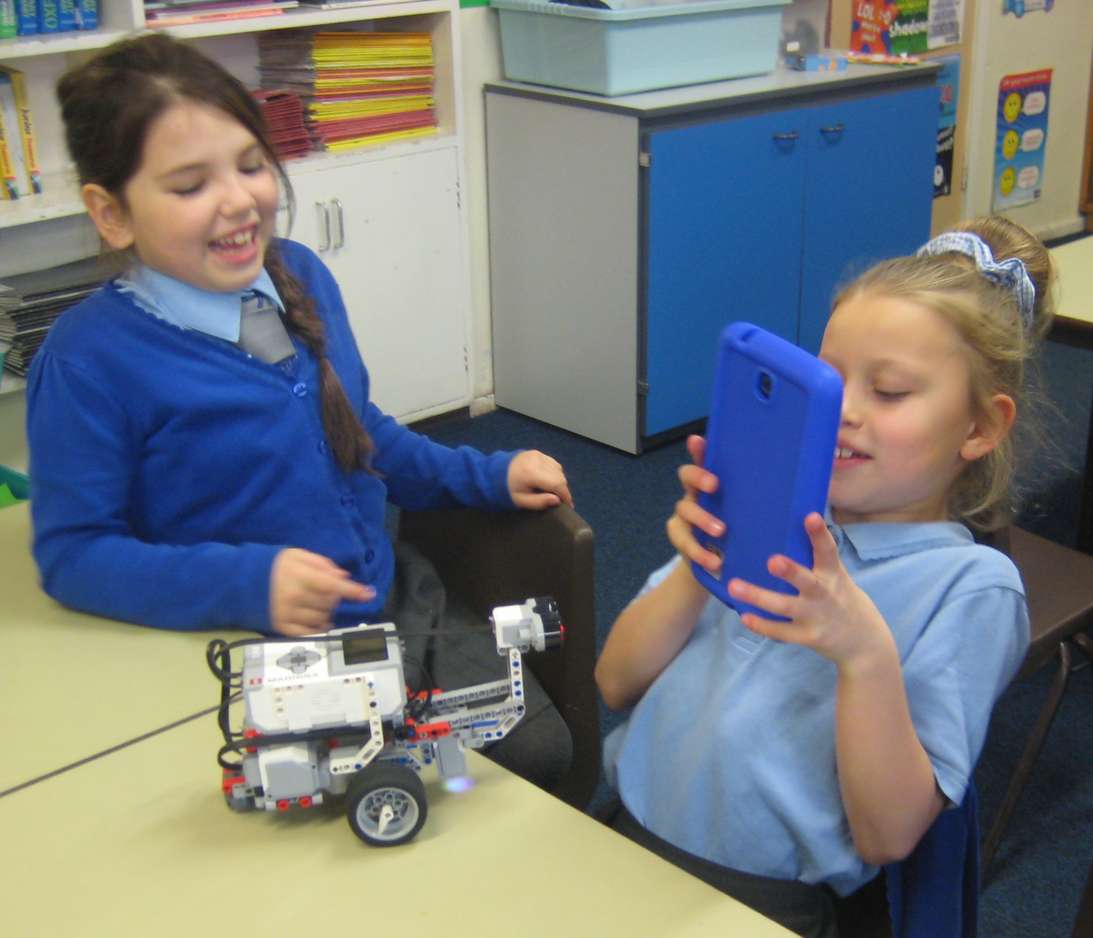 Picture of two primary girls working with a Lego Robot